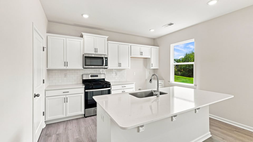 Kitchen with island and cabinets.