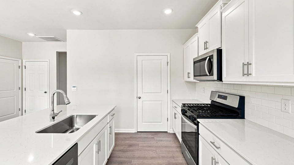 Kitchen with island and cabinets.