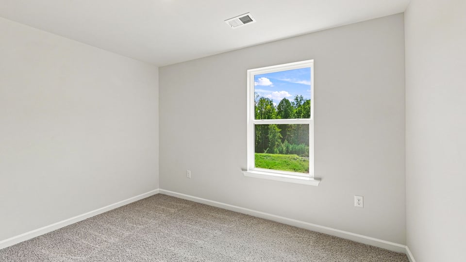 Bedroom with carpet and windows.