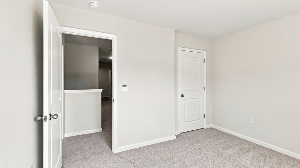 Bedroom with carpet and windows.
