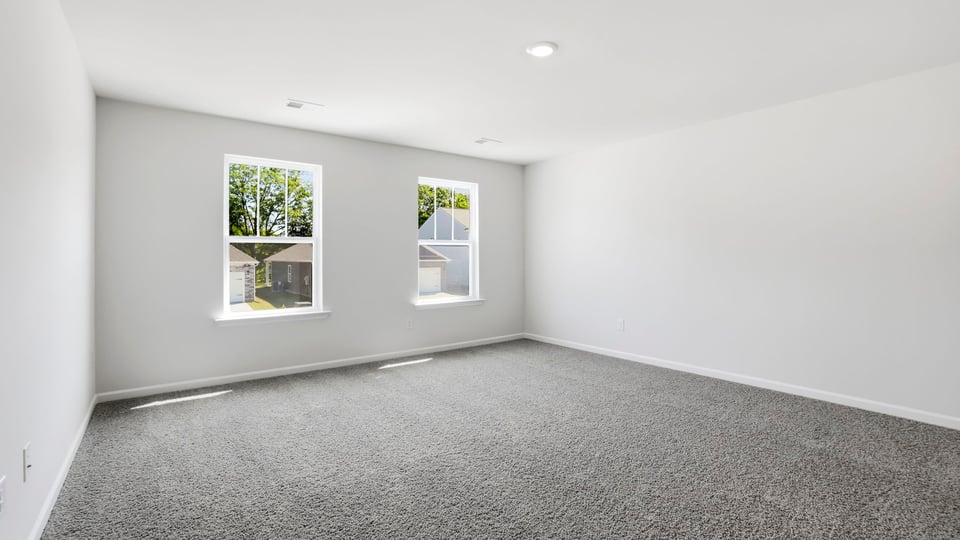 Bedroom with carpet and window.