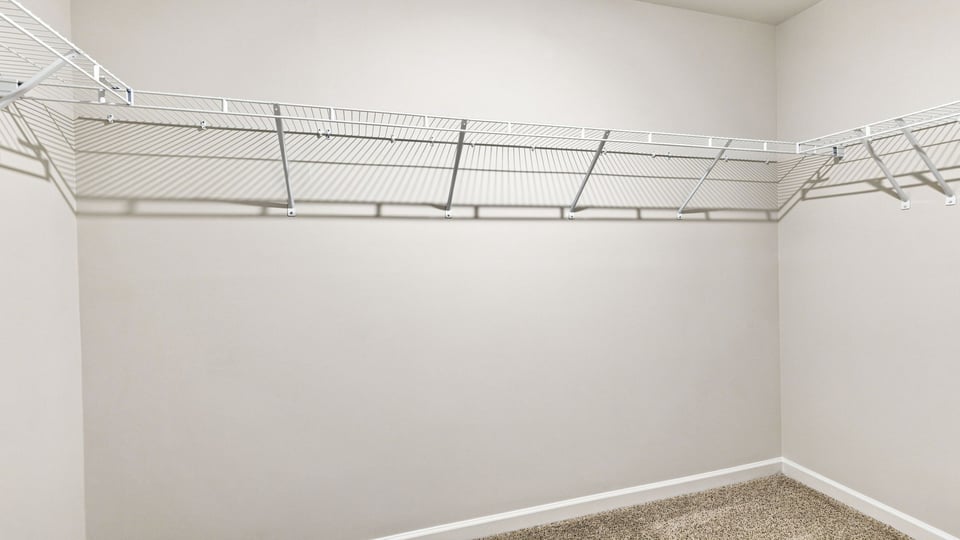 Primary closet with shelf.