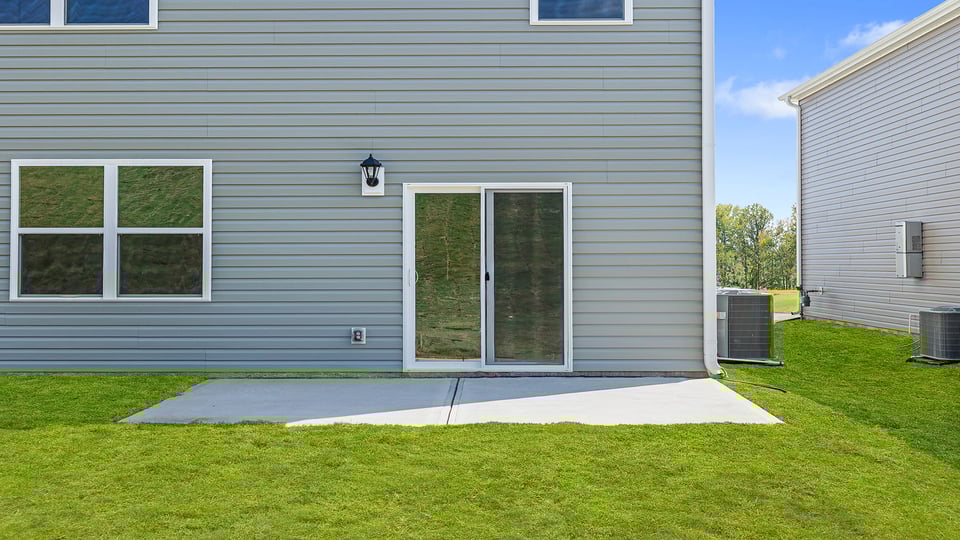 Exterior of home with large backyard.