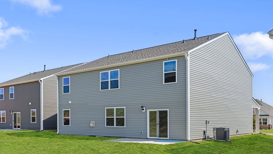 Exterior of home with large backyard.