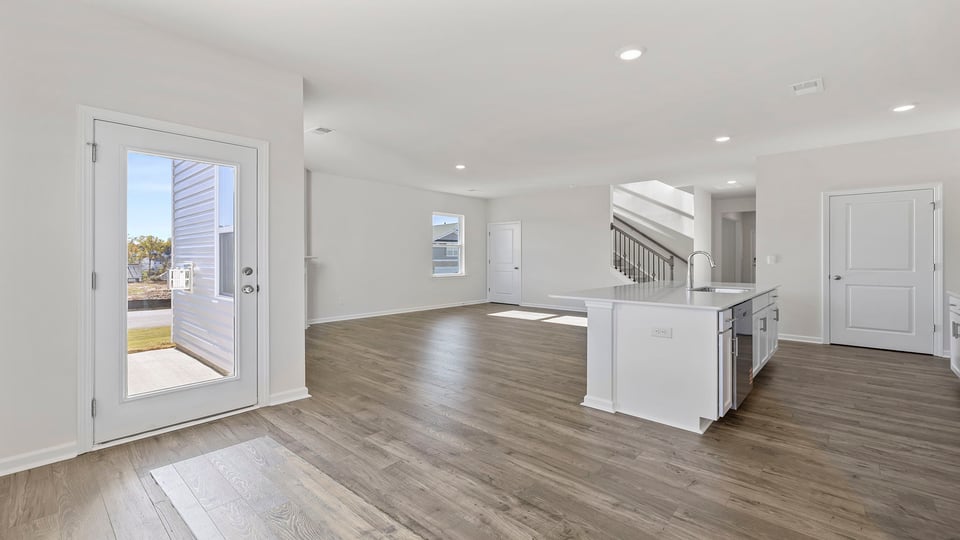 Kitchen and dining room view with windows.