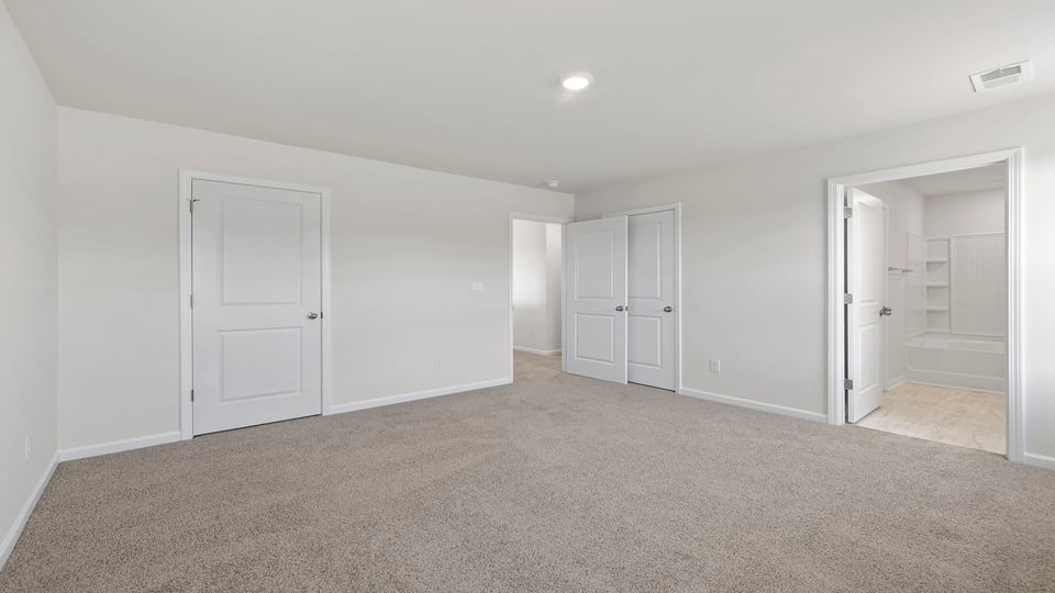 Bedroom with carpet and window.