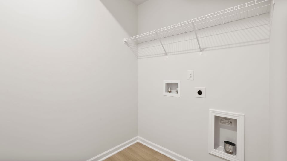 Laundry room with hanging storage racks.
