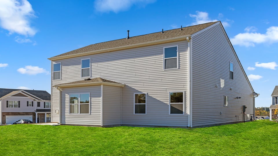 Exterior of home with large backyard.