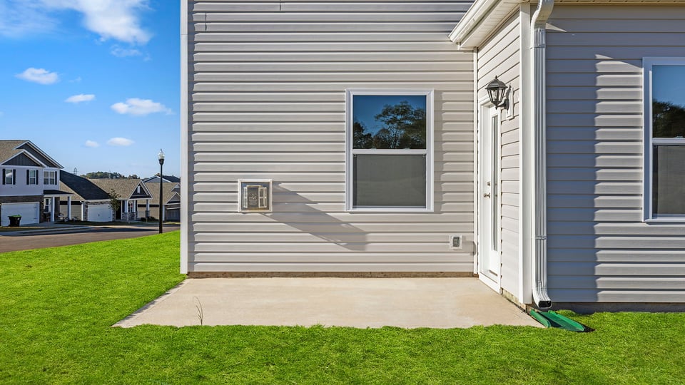 Exterior of home with large backyard.