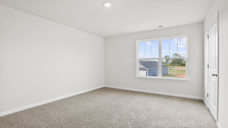 Bedroom with carpet and window.