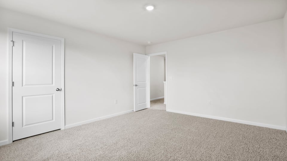 Bedroom with carpet and window.