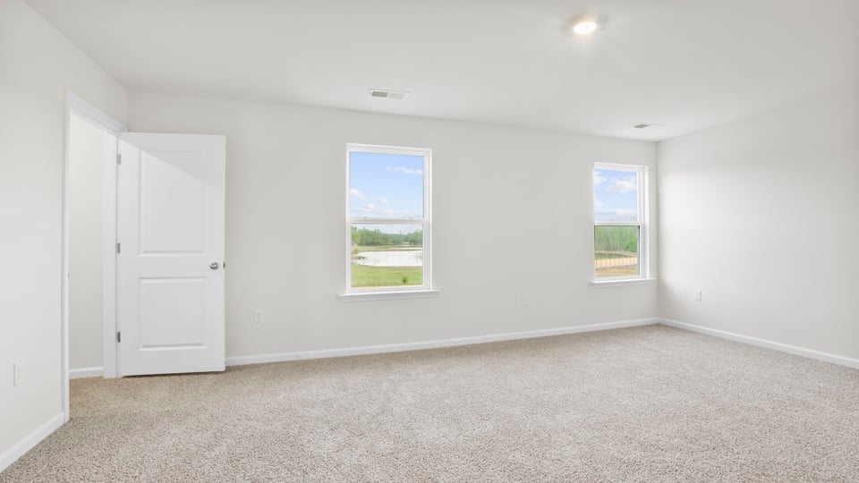 Bedroom with carpet and window.