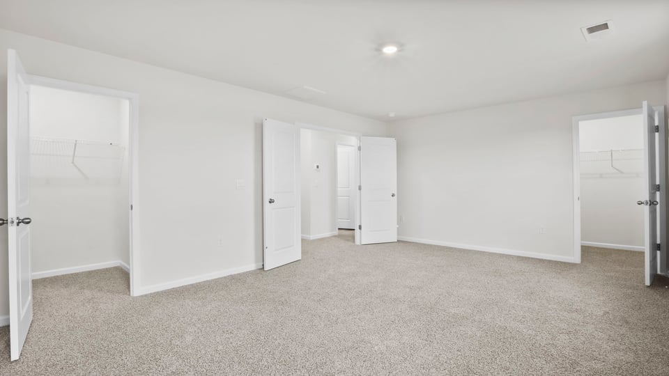 Bedroom with carpet and window.