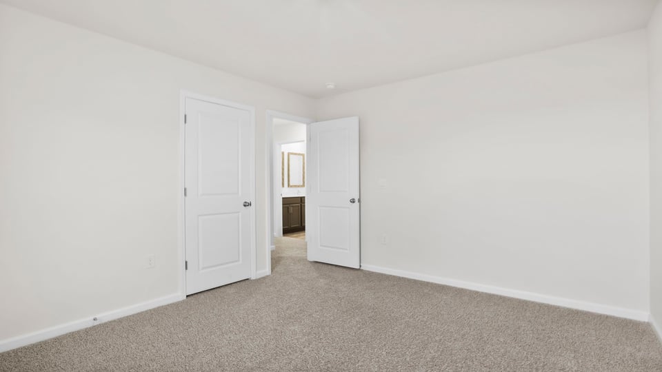Bedroom with carpet and window.