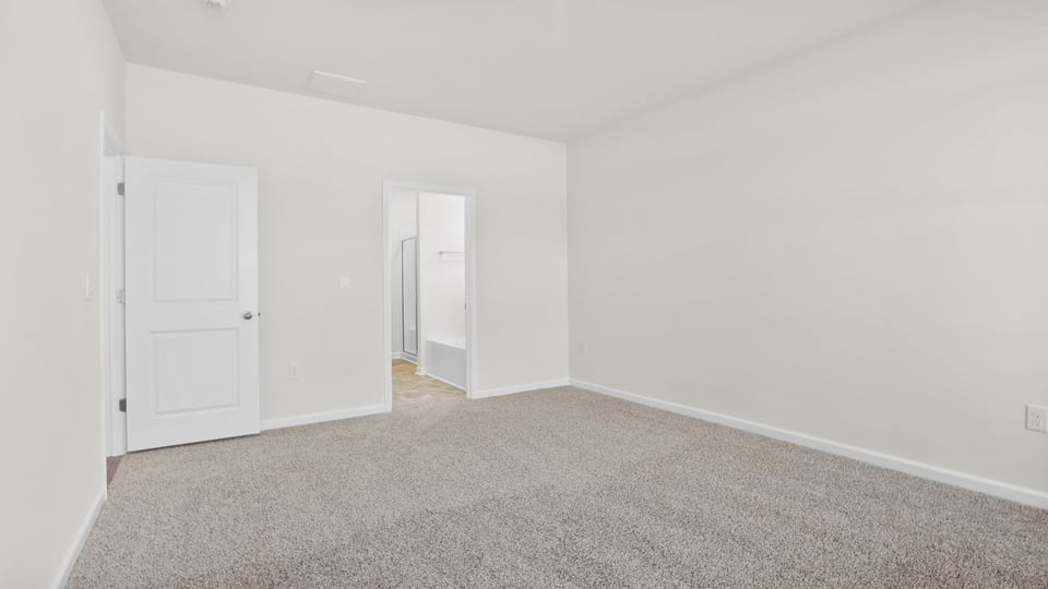 Bedroom with carpet and window.