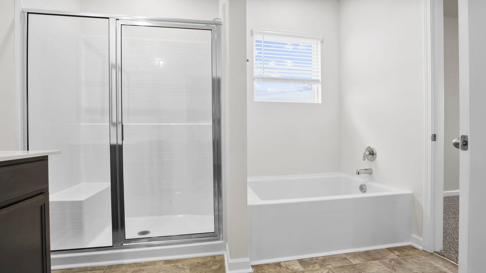 Bathroom with tub and walk in shower.