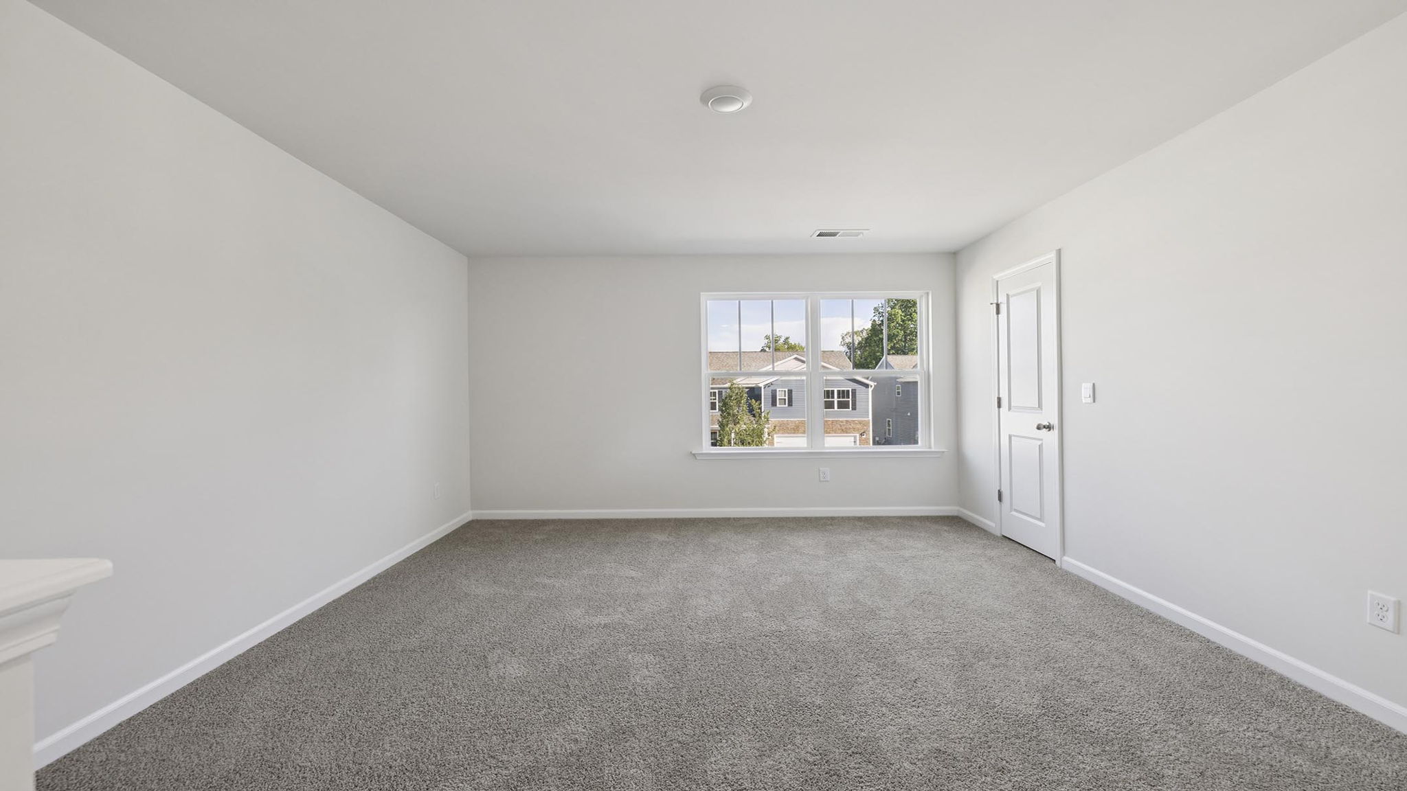 Bedroom with carpet and windows.