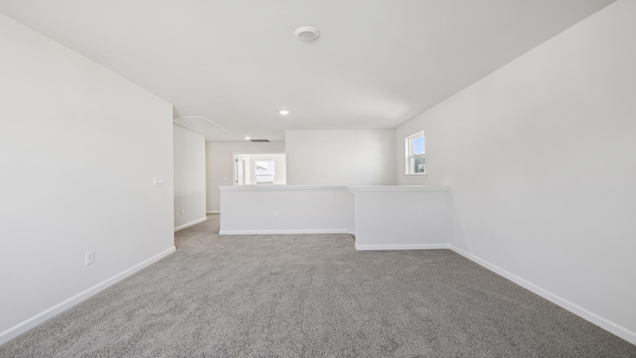 Bedroom with carpet and windows.