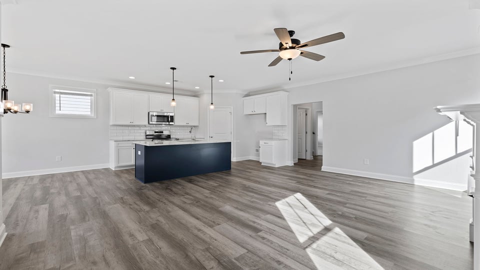 Family room with fireplace and ceiling fan.
