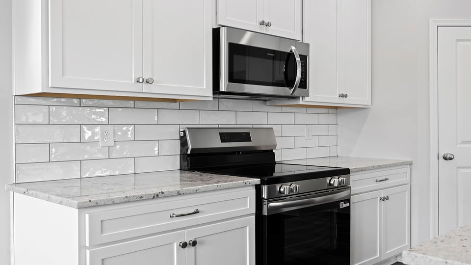 Kitchen with granite countertops and stainless steel appliances.