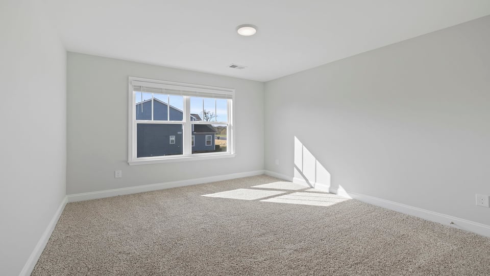 Bedroom with carpet and windows.