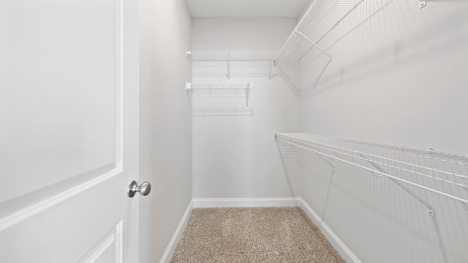 Walk in closet with shelves.