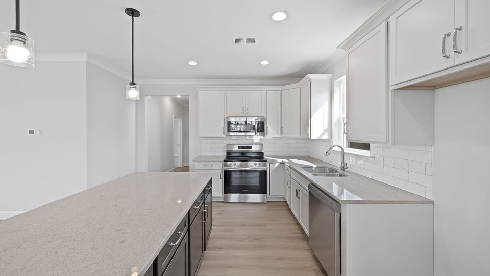 Kitchen with granite countertops and stainless steel appliances.