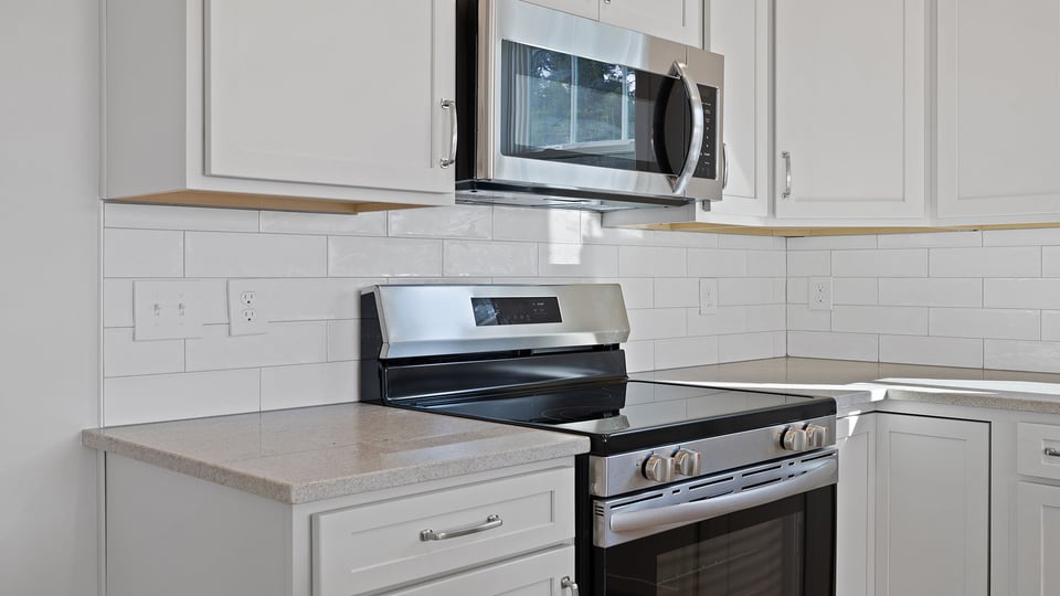 Kitchen with granite countertops and stainless steel appliances.