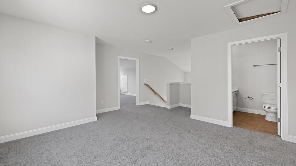 Loft area with carpet.