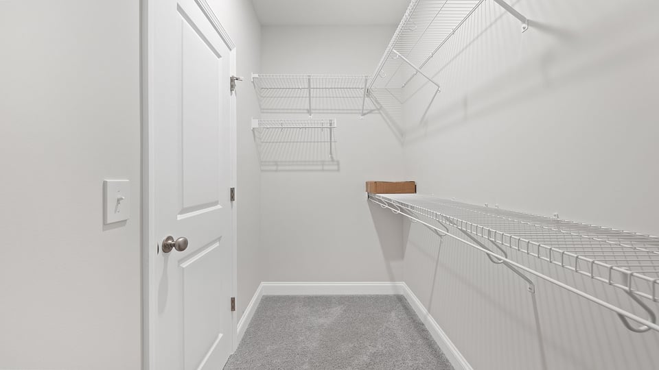 Walk in closet with shelves.