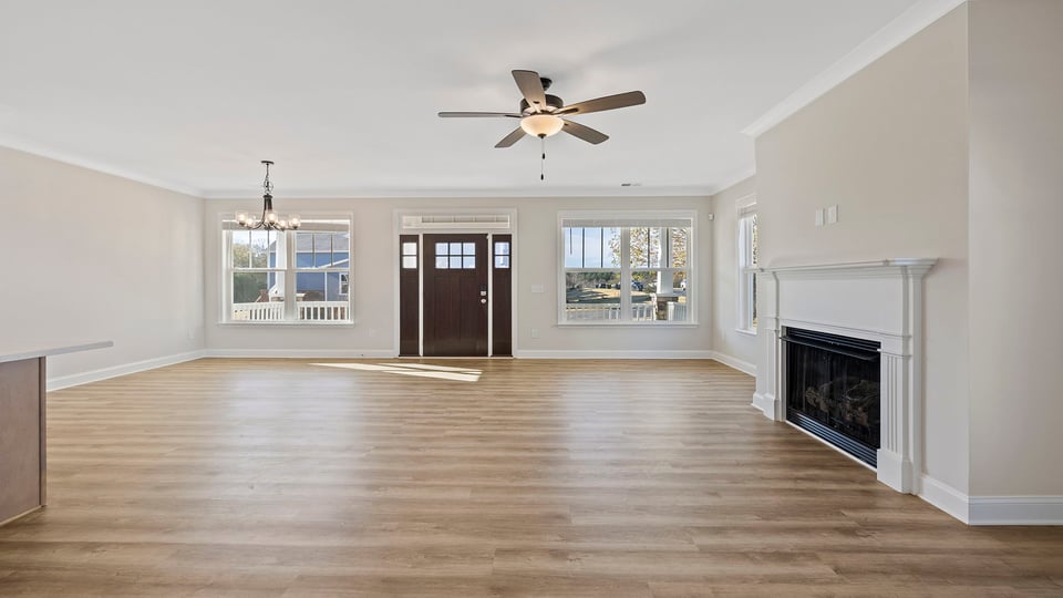 Family room with ceiling fan and fireplace.