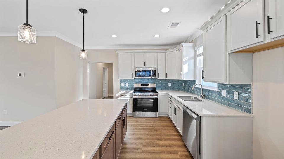 Kitchen with stainless steel appliances and granite countertops.