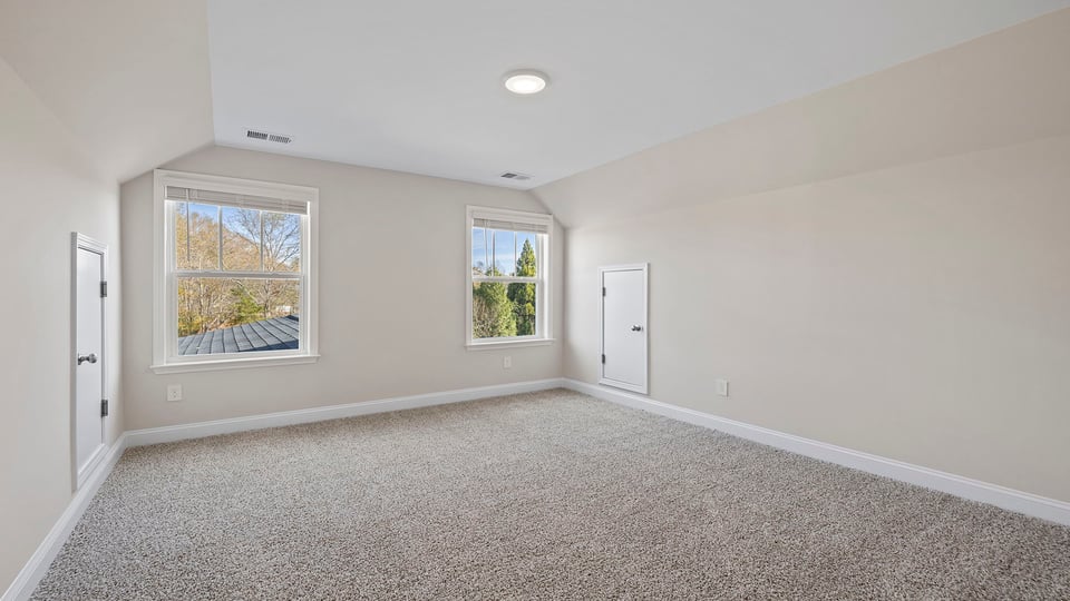 Bedroom with carpet and window.