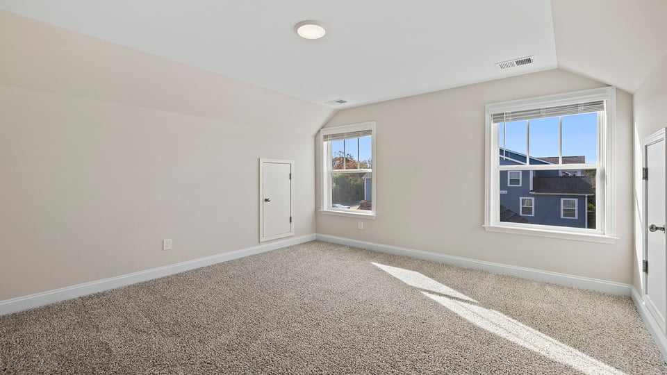 Bedroom with carpet and window.