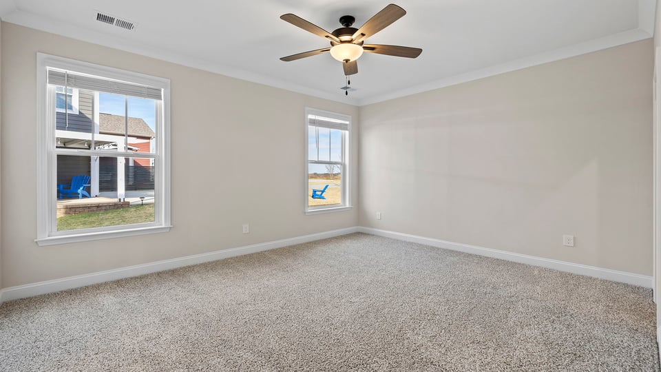 Bedroom with carpet and window.