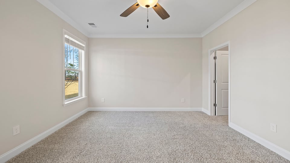 Bedroom with carpet and window.