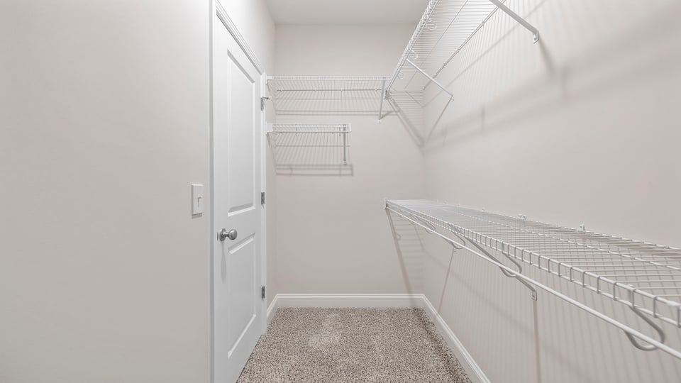 Walk in closet with shelves.