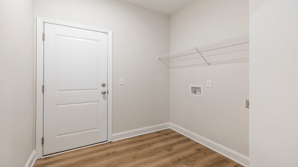 Walk in laundry with shelves.