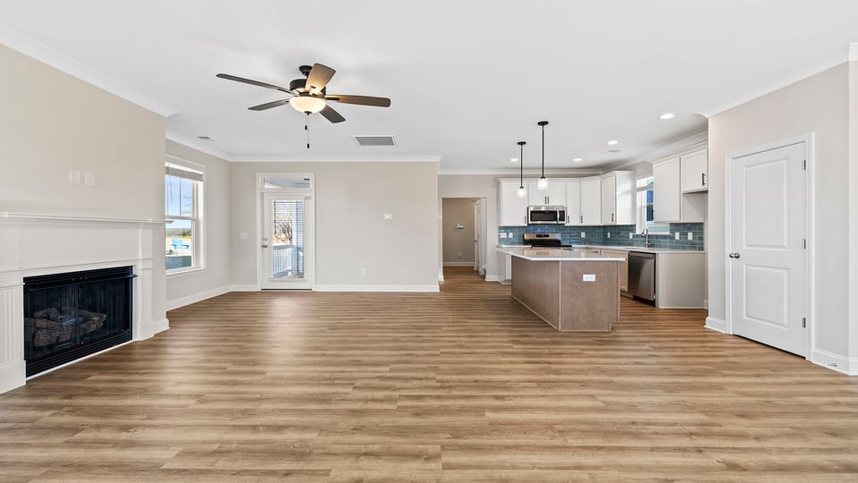 Family room with ceiling fan and fireplace.