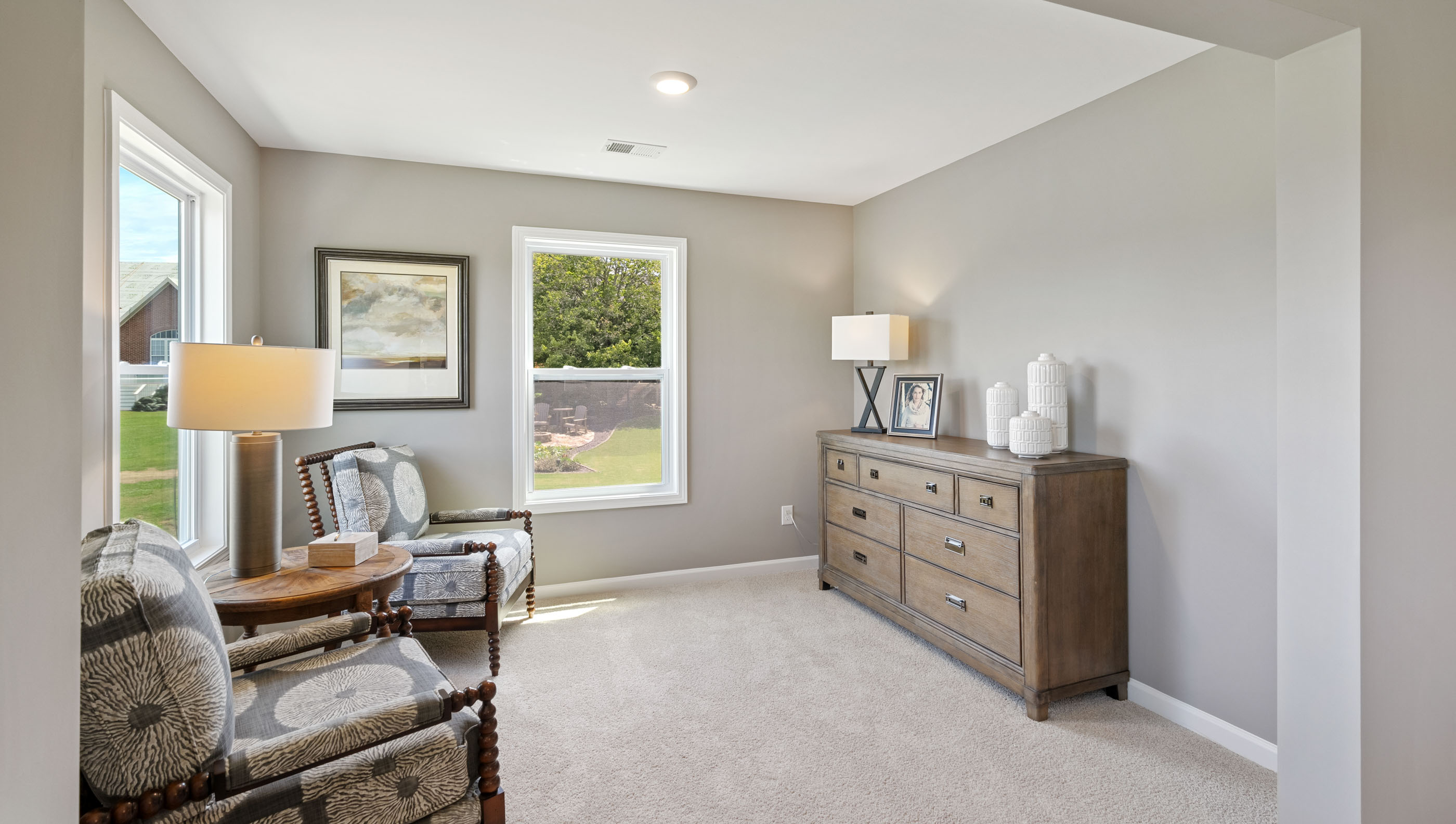 Bedroom with carpet and windows.