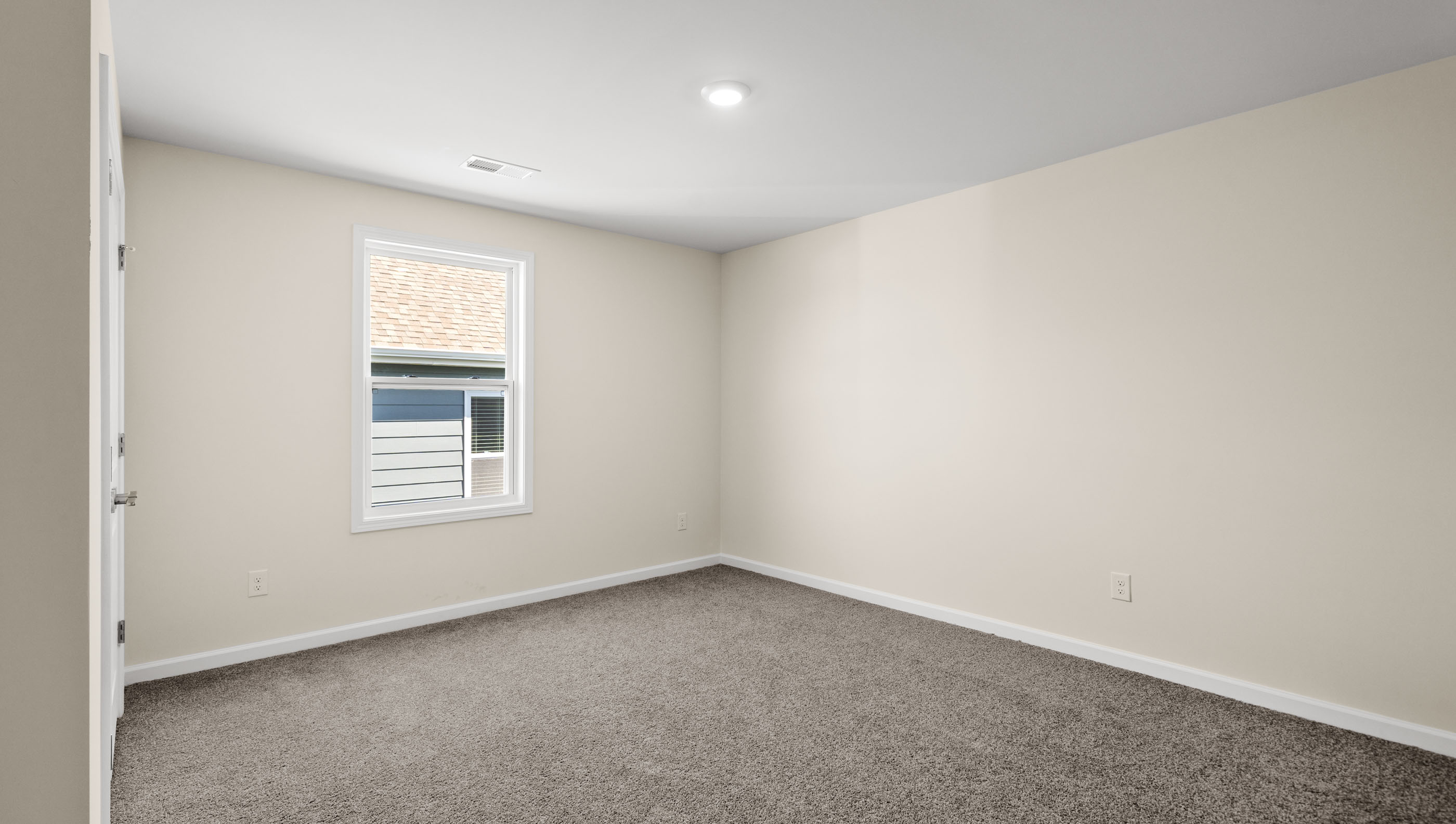 Bedroom with carpet and windows.