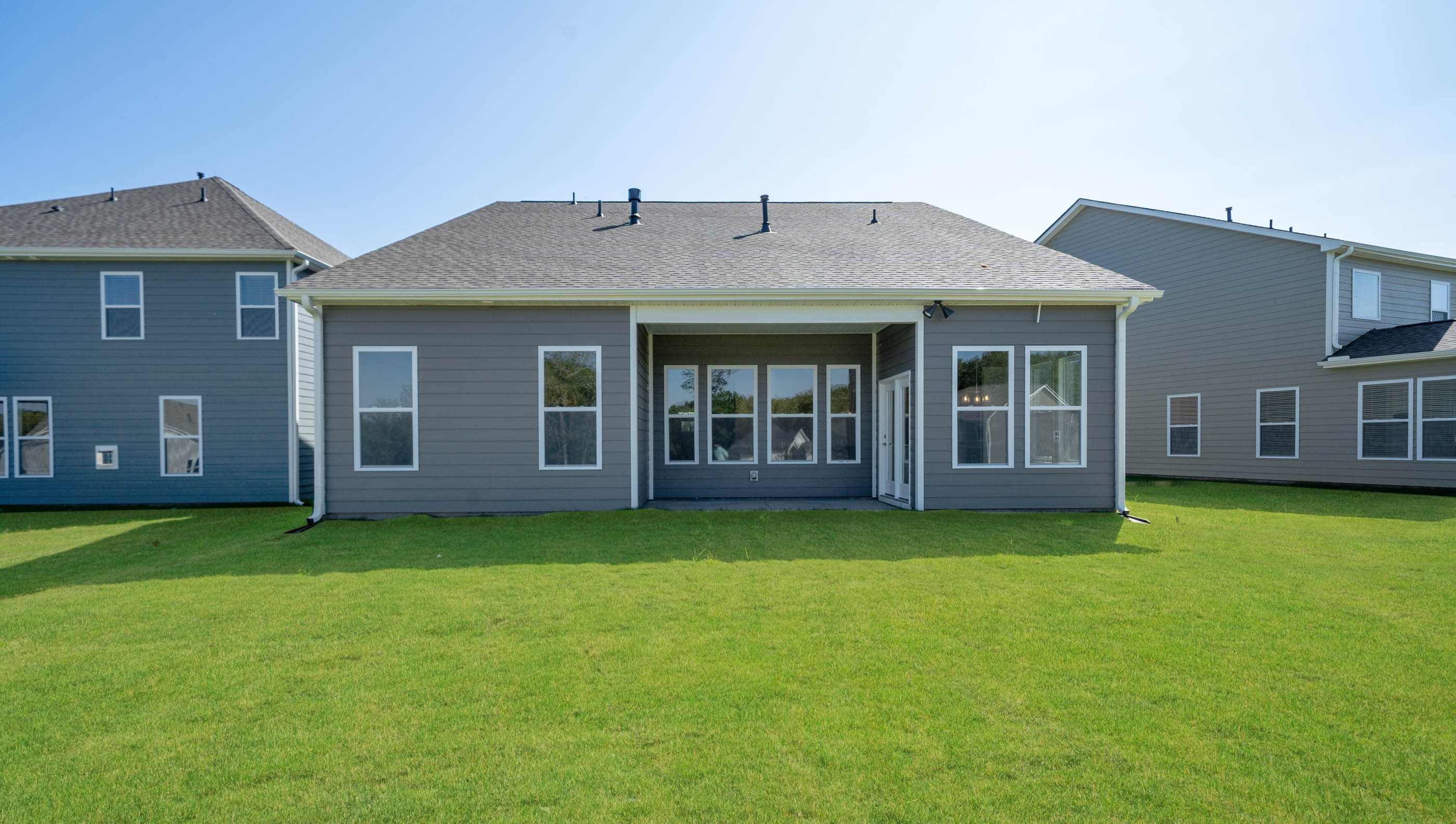 Back exterior of home with large backyard.
