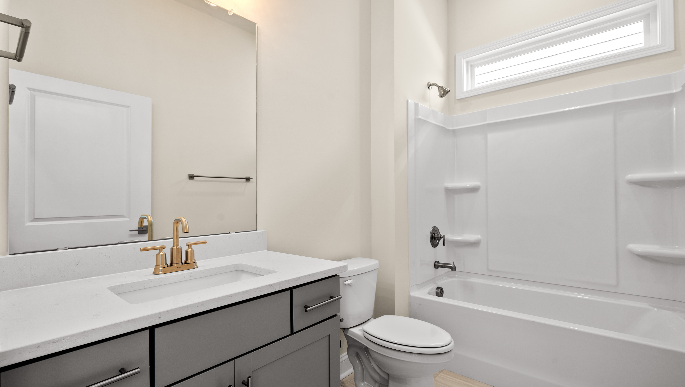 Bathroom with single vanity sink and tub.