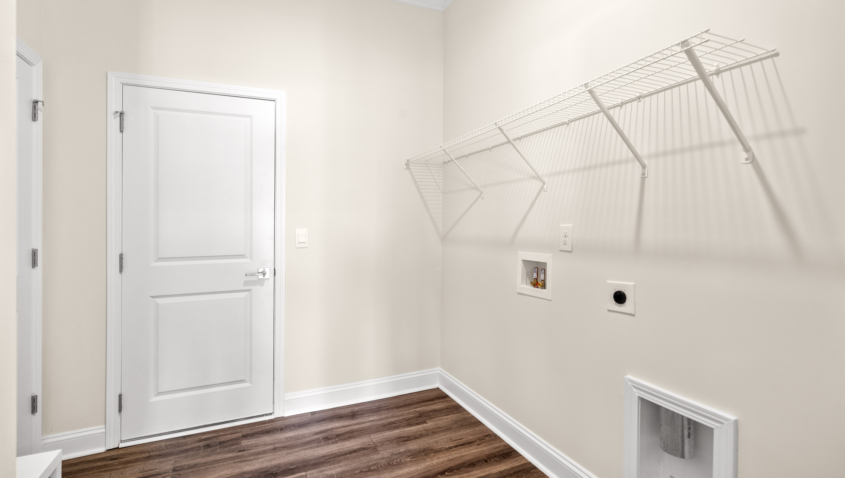 Laundry room with hanging storage racks.