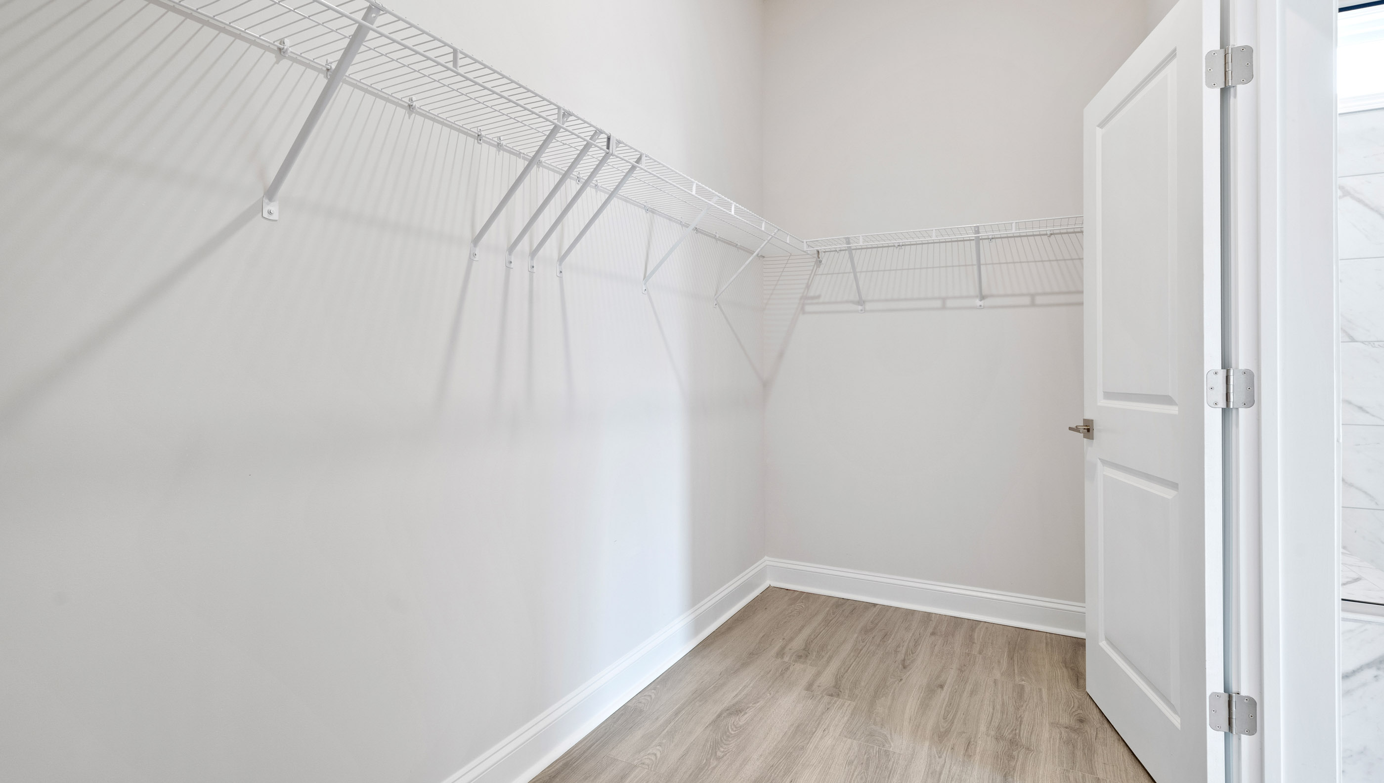 Closet with hanging storage racks.