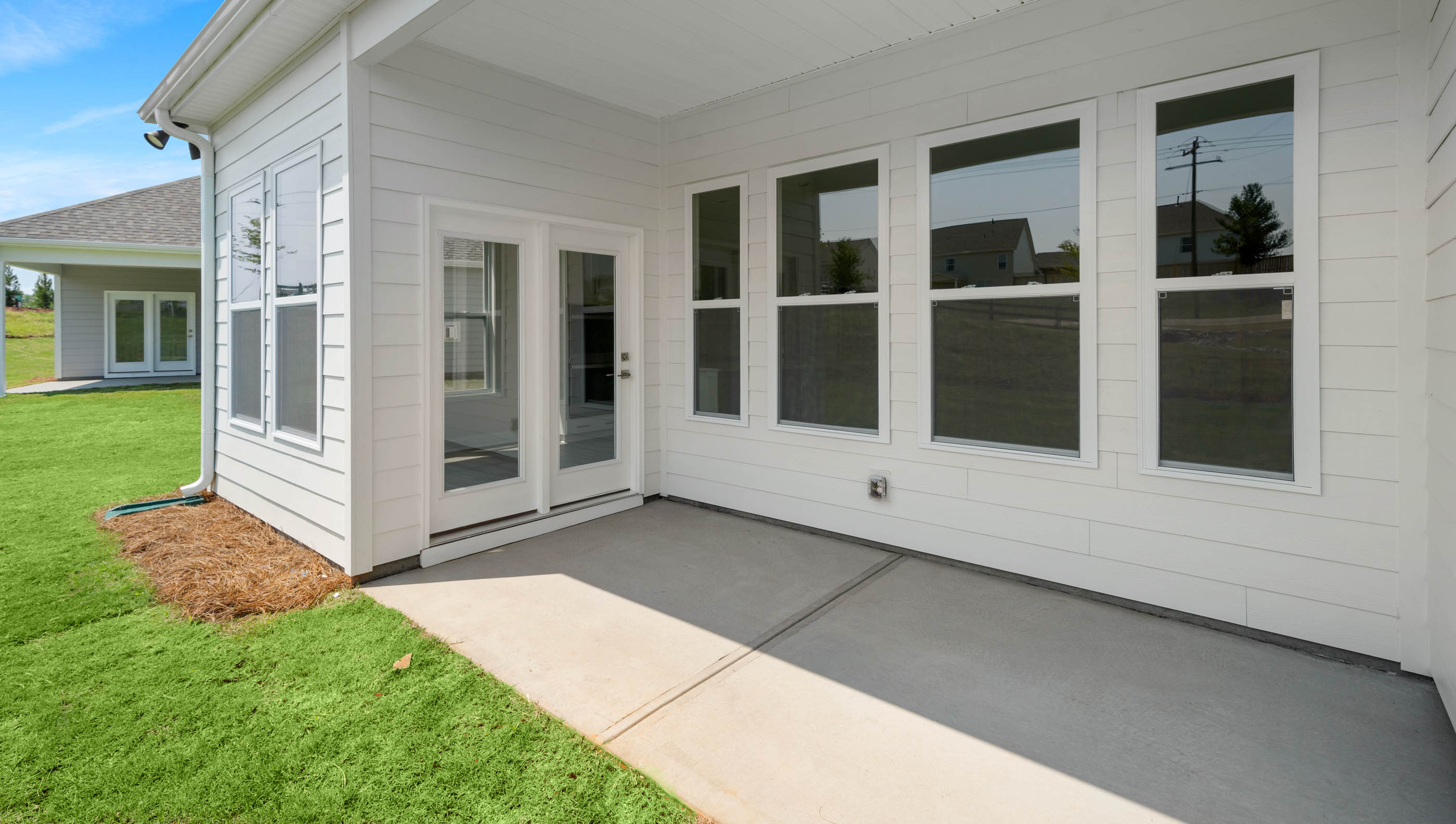 Back exterior of home with patio.
