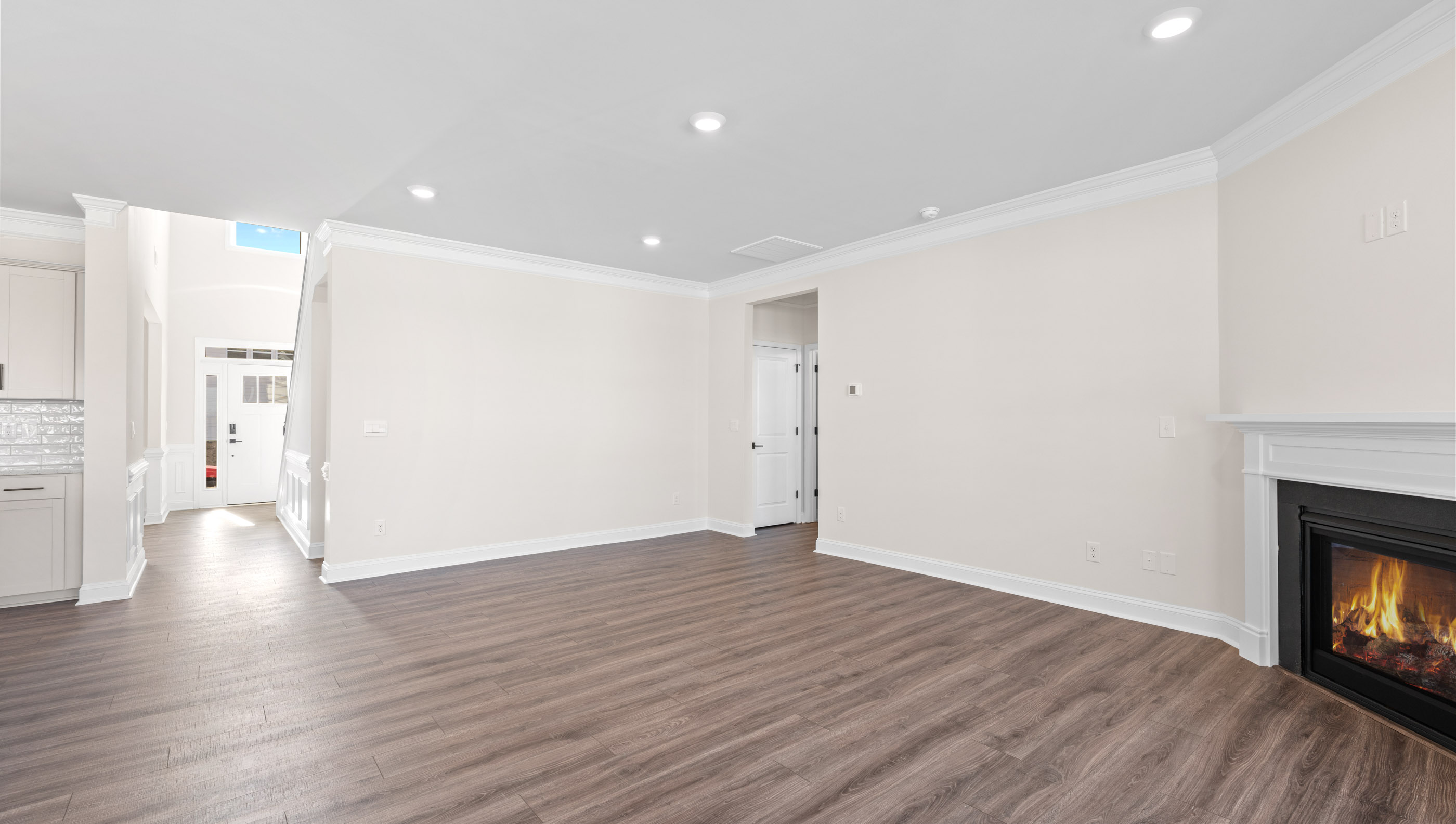 Family room with fireplace and windows.