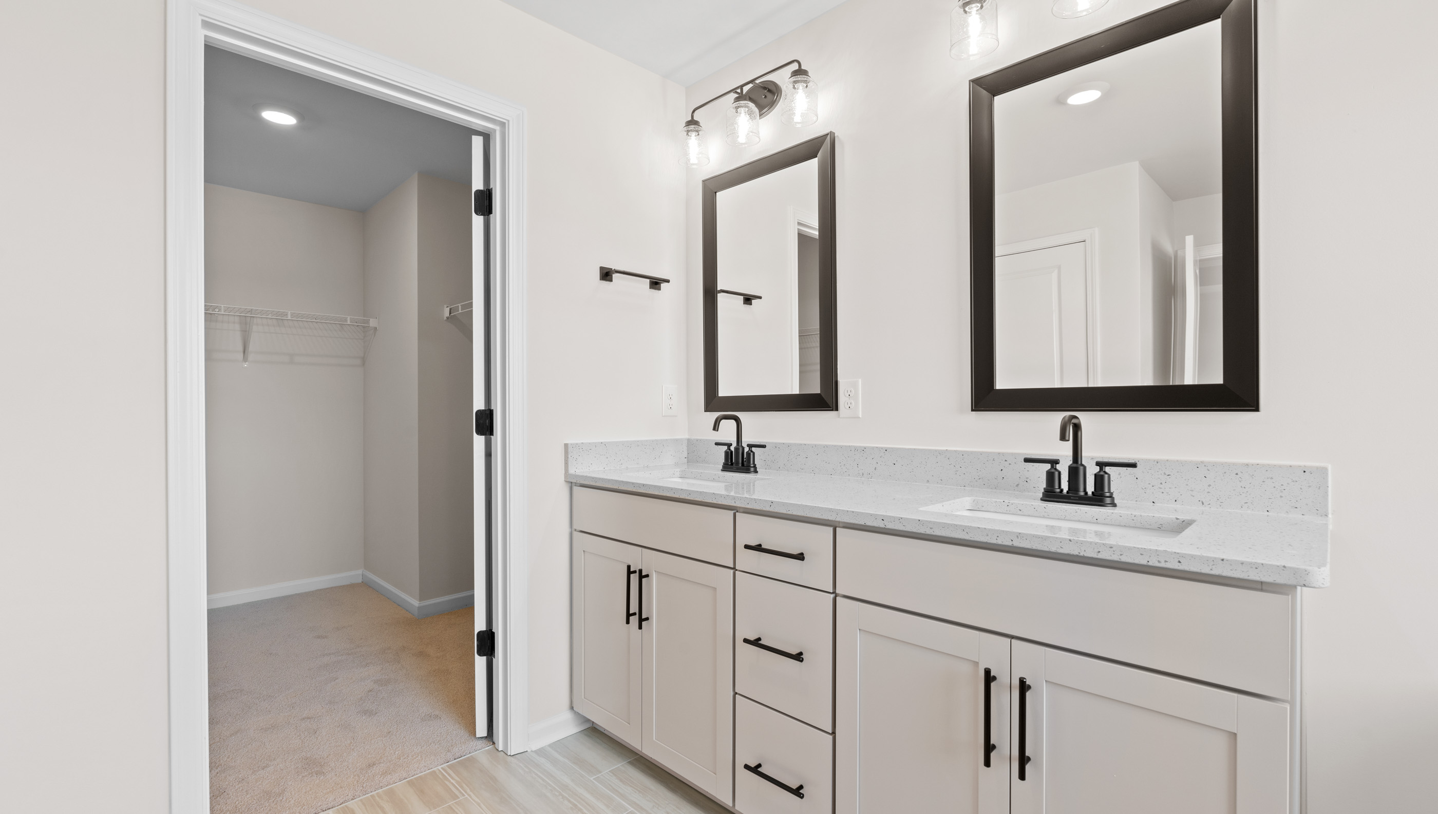 Bathroom with double vanity sink and closet.