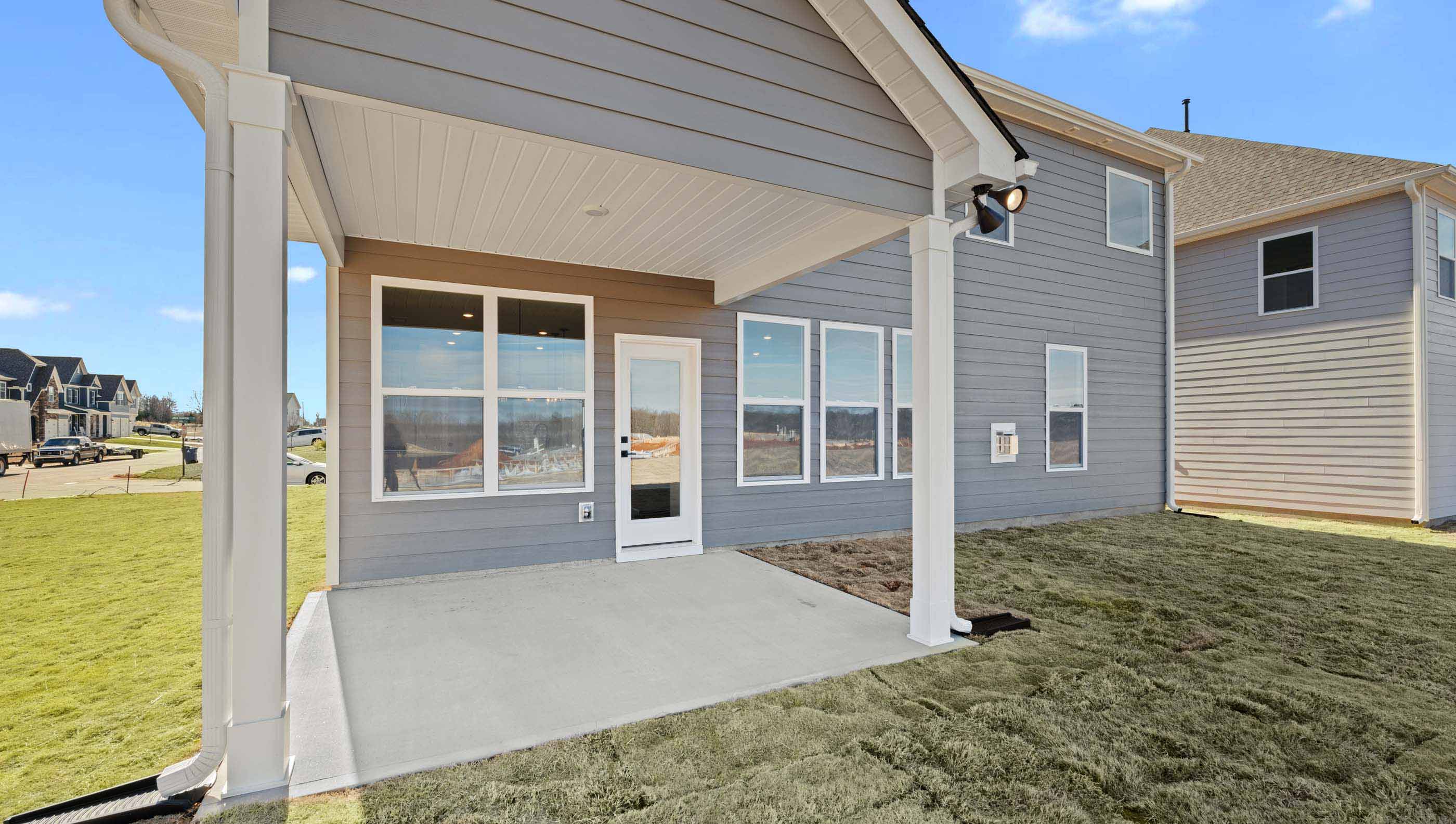 Back exterior of home with small patio.