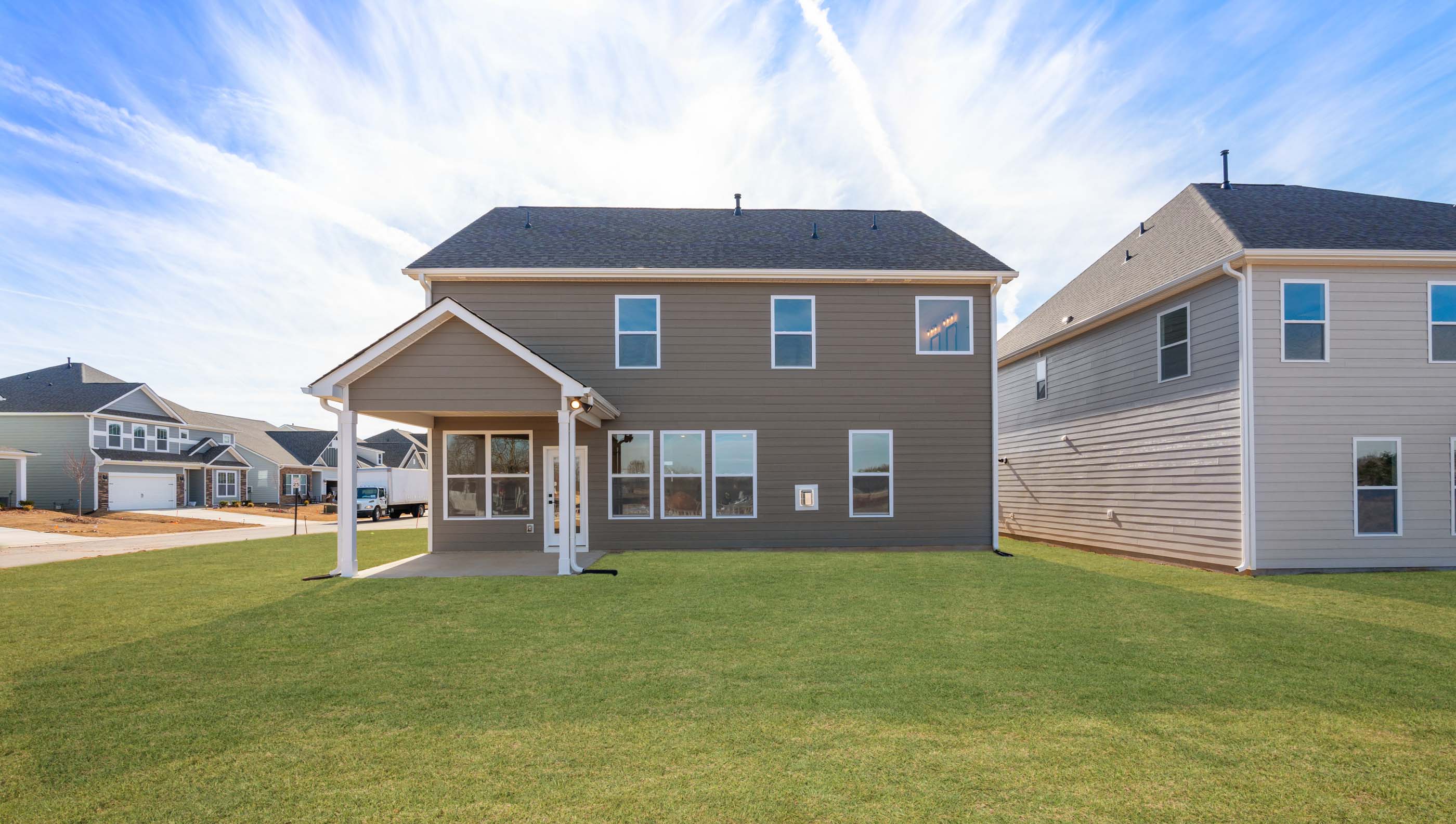 Back exterior of home with large backyard.